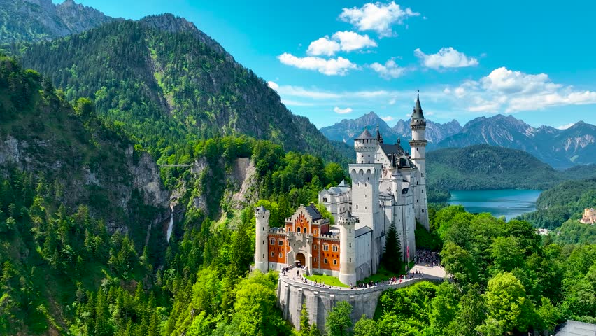 A view of Neuschwanstein Castle,  a 19th-century fairy-tale-like palace perched on a rugged hill above the village of Hohenschwangau in southwest Bavaria, Germany