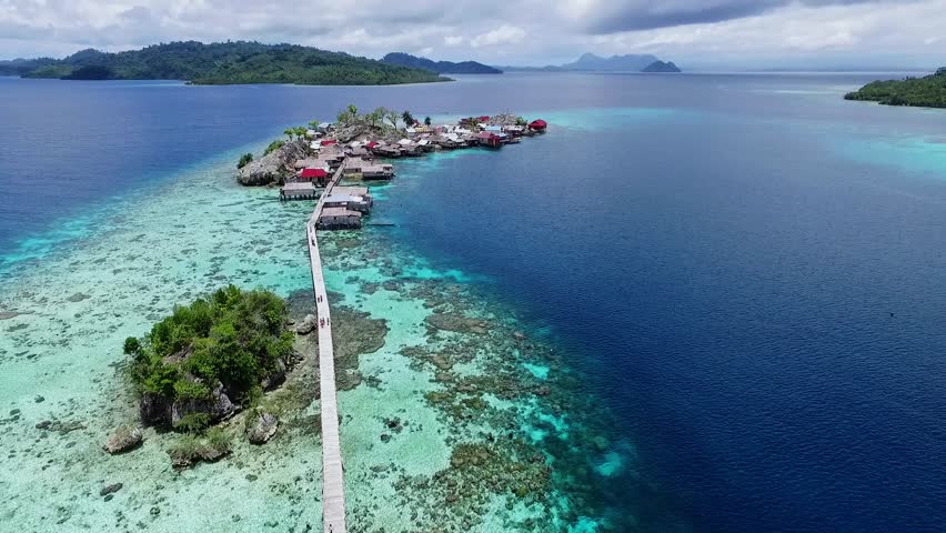 Togean islands, central sulawesi, Indonesia - September 2017: beautyful aerial view of sea gypsy houses "bajau trible village". natural blue water, white sand and coral reefs surround their homes