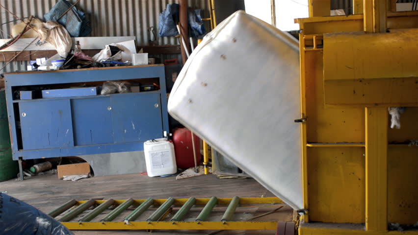 WOODANILLING, AUSTRALIA - November 21, 2012: A shedhand removing a bale of wool