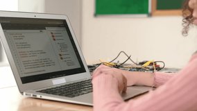Back view of american girl coding engineering prompt while laptop screen display programing software to generate AI at table with mother board. Smart attractive student working on computer. Pedagogy. - Powered by Shutterstock - Get 15% off with code: PIKWIZARD15