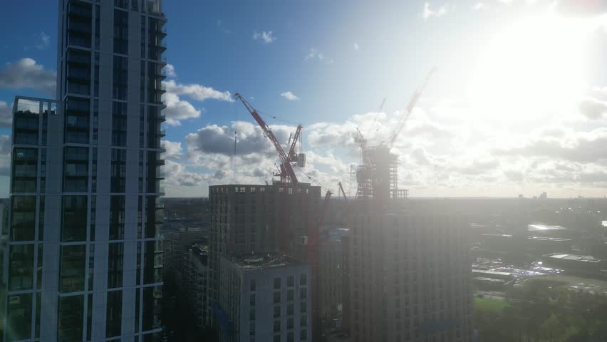 A construction site dominated by cranes , emphasizing growth and the evolution of the urban landscape in modern cities in London UK