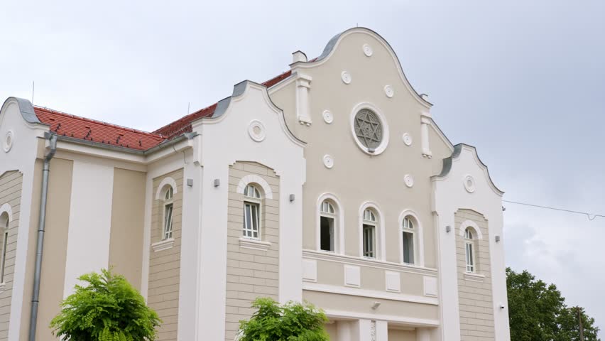 Historic building showcasing classical architecture in a vibrant urban setting during daylight hours
