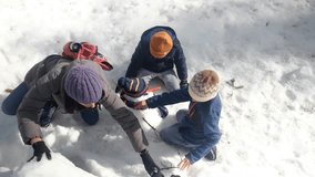 Children building a snowman in a snowy forest. Concept: childhood and winter fun. Bright, natural lighting. - Powered by Shutterstock - Get 15% off with code: PIKWIZARD15