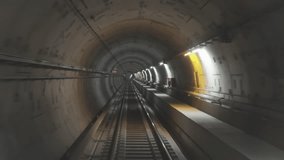 Driverless metro train moves through a well-lit underground tunnel featuring concrete walls and tracks. The tunnel is straight and lined with bright lights along its length, in Thessaloniki, Greece. - Powered by Shutterstock - Get 15% off with code: PIKWIZARD15