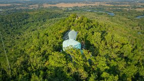Aerial view of amazing golden sunrise at f Phra Yai Wat Phra That Doi Phra Chan (Daibutsu) on the mountain in Lampang Thailand. Bright blue sky. Clear skies and natural beauty background. - Powered by Shutterstock - Get 15% off with code: PIKWIZARD15