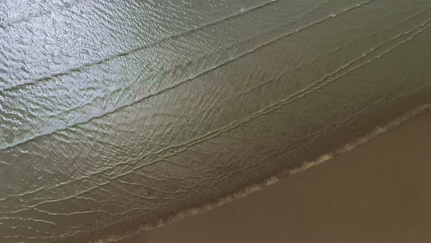 Aerial footage of mudflats Cungulla Beach, Townsville, North Queensland, Australia.