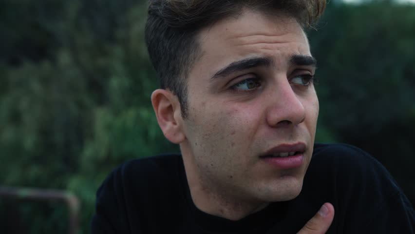 Cold Young Man On A Winter Evening Shivers And Warms Up Outside