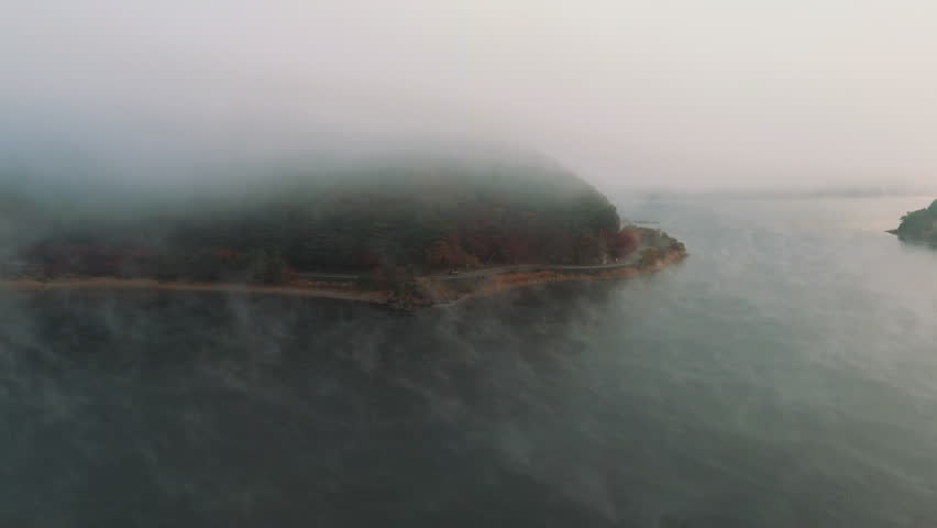 4K Aerial Fly Over fog foggy weather over lake fall mystic atmosphere