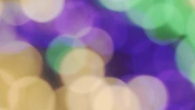 Bokeh of Mardi Gras beads in yellow or gold green and purple. Celebrating Mardi Gras, aka Fat Tuesday. Mardi Gra background in traditional colors. - Powered by Shutterstock - Get 15% off with code: PIKWIZARD15