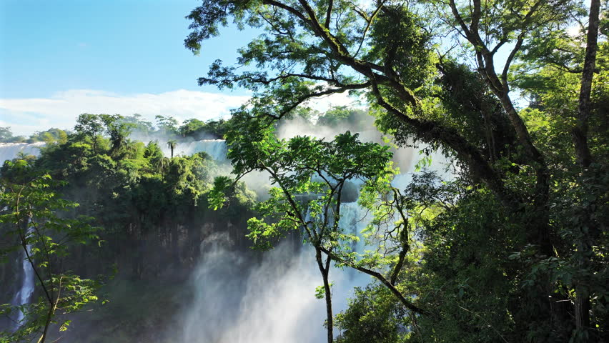 The magnificent Iguazu Falls on a sunny day in Iguazu National Park, located in the province of Misiones, Argentina.