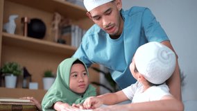 Asian muslim children are learning and studying Muslim religion with their father. A muslim man teaches his son and daughter homework and study Quran - Koran at home. Modern islam family lifestyle. - Powered by Shutterstock - Get 15% off with code: PIKWIZARD15