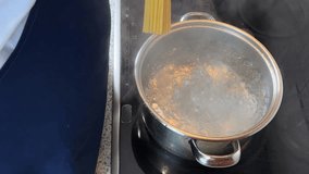 Cooking spaghetti in boiling water on a kitchen - Powered by Shutterstock - Get 15% off with code: PIKWIZARD15