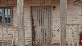 Old weathered wooden door and porch of an abandoned house in Morocco. Peeling paint and broken window add to the rustic charm. This scene evokes feelings of nostalgia, history, and decay. - Powered by Shutterstock - Get 15% off with code: PIKWIZARD15