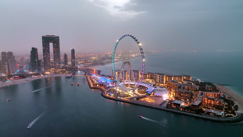 Aerial view of Ain Dubai ferris wheel illuminated at night on Bluewaters Island in Dubai Marina
