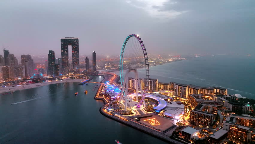 Aerial view of Ain Dubai ferris wheel illuminated at night on Bluewaters Island in Dubai Marina