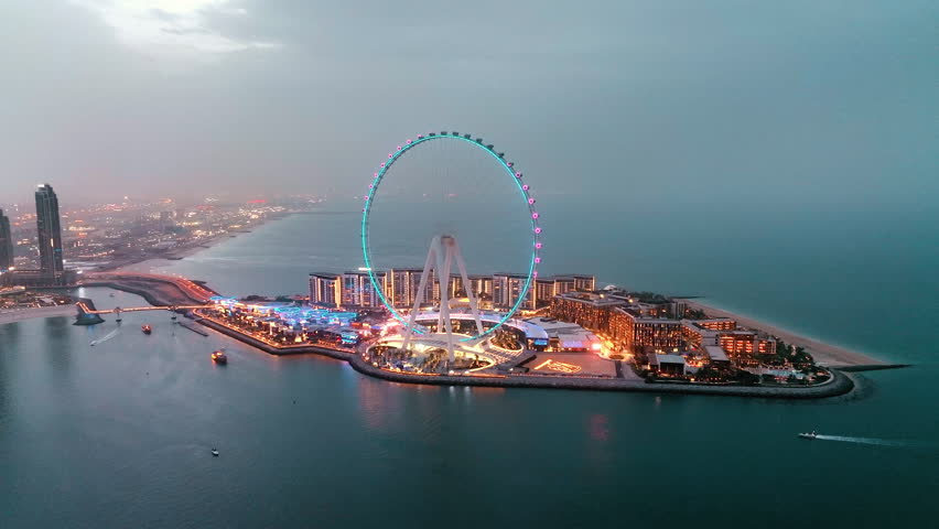 Aerial view of Ain Dubai ferris wheel on Bluewaters Island illuminated at night in Dubai Marina