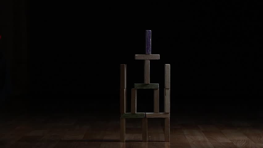 soft bullet destroys a building made of wooden blocks. Slow motion