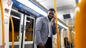 Professional businessman talking on smartphone while standing inside subway train during morning commute, embodying modern urban communication lifestyle - Powered by Shutterstock - Get 15% off with code: PIKWIZARD15