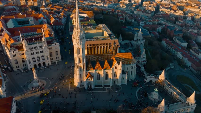 Aerial view of Budapest castle hill at sunset with Danube river and Matthias church, capital of Hungary establishing shot