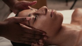 Close-up shot of brunette girl with closed eyes getting neck and face massage while visiting wellness centre - Powered by Shutterstock - Get 15% off with code: PIKWIZARD15