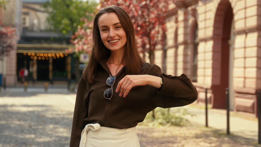 Friendly smiling Caucasian woman girl female lady businesswoman stylish business pointing finger at camera hey you come here gesture invite welcome follow inviting join in city outdoors urban travel