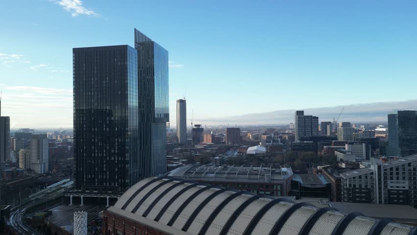 Aerial drone shot across Manchester shot from the west looking east at Deansgate Square, Manchester, UK