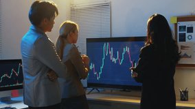 Professional business team analyzing financial data and discussing stock market trends during late night collaborative office meeting, highlighting corporate teamwork and strategic planning - Powered by Shutterstock - Get 15% off with code: PIKWIZARD15