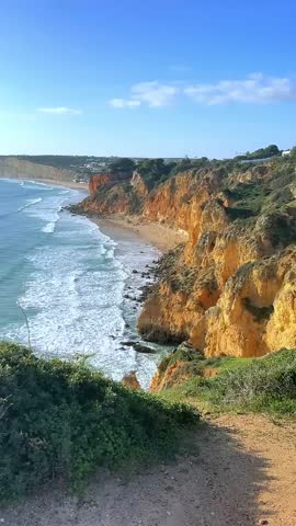 Travel background with a breathtaking panoramic view of the Algarve coast in Lagos, Portugal, showcasing dramatic golden cliffs, turquoise waters, and a rugged coastline