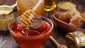 Honey stick and bowl of honey, close-up - Powered by Shutterstock - Get 15% off with code: PIKWIZARD15