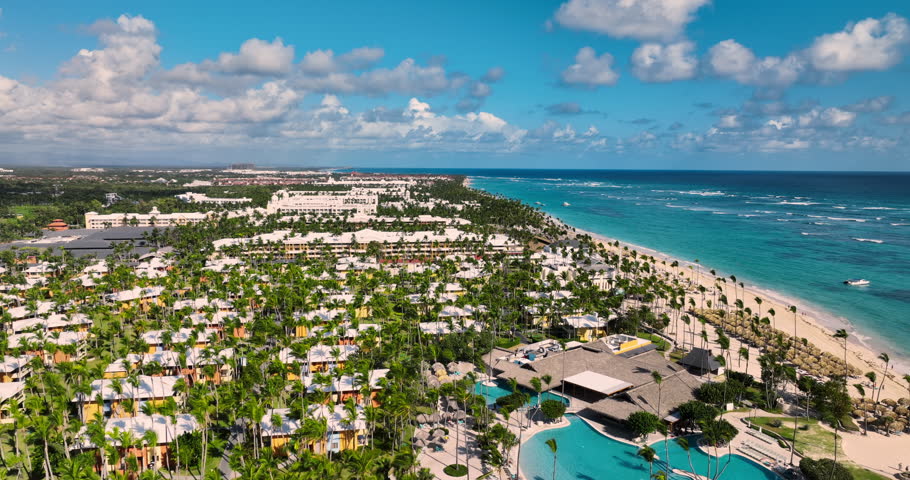 Aerial panorama landscape of tropical resort Bavaro, Punta Cana, Dominican Republic, sunrise over caribbean sea, coastline with umbrellas and loungers and hotel pools and villas