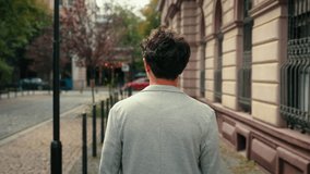 Back view from behind unrecognizable man unknown guy walking outdoors going in city turning around smiling pointing looking at camera hey you smile toothy male portrait tourist outdoor walk at street - Powered by Shutterstock - Get 15% off with code: PIKWIZARD15