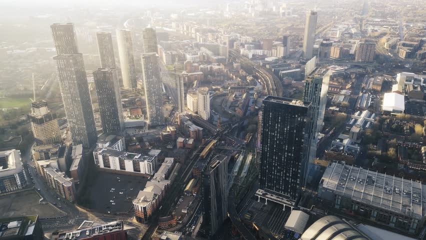 Aerial drone shot across Manchester shot from the west looking east at Deansgate Square, Manchester, UK