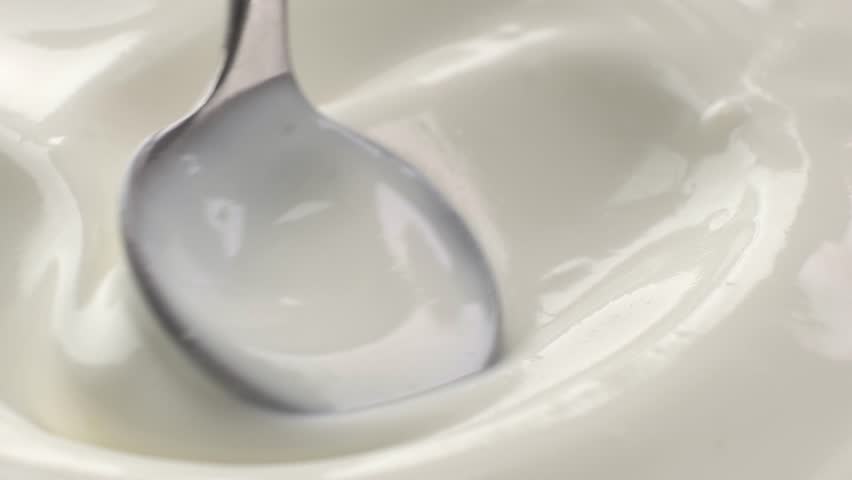 Close-up of spoon and natural yogurt texture, concept video for commercial