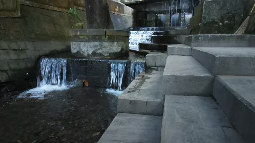 Clear water flows from the pool at Sedudo tourist attraction, Nganjuk, Indonesia