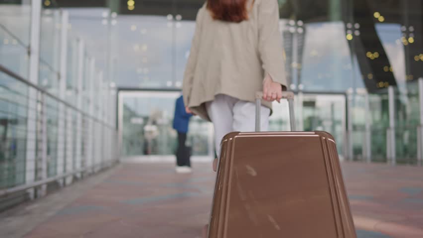 Asian businessman and woman walking in airport terminal to boarding gate. Attractive young couple tourist passenger feeling happy and excited going travel abroad by airplane for holiday vacation trip.