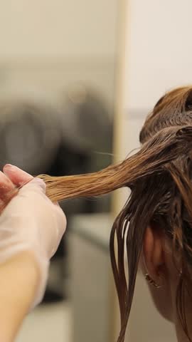 Close-up of the hair care process in a modern high-class salon. Hair coloring