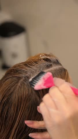 Close-up of hair coloring demonstrates precise salon techniques to ensure the best results every time. Hair care