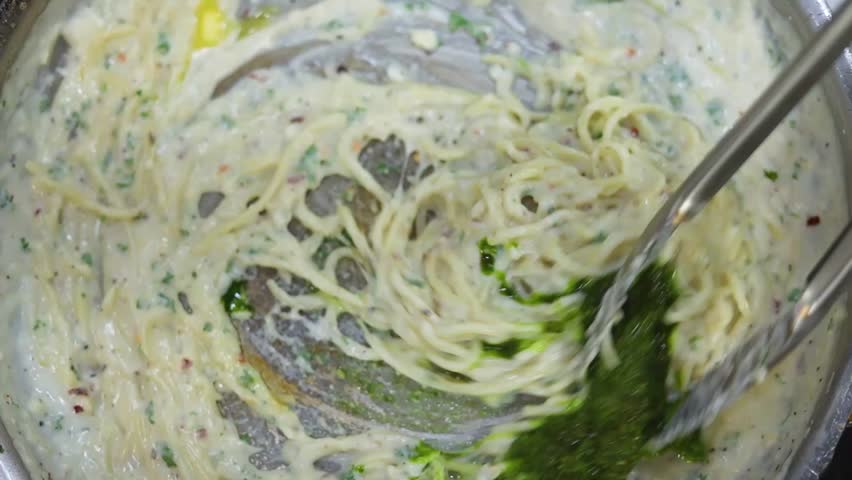 Pesto spaghetti pasta is a flavorful dish made with al dente spaghetti tossed in a vibrant green pesto sauce. The sauce, a blend of fresh basil, garlic, pine nuts, Parmesan, and olive oil, adds a rich