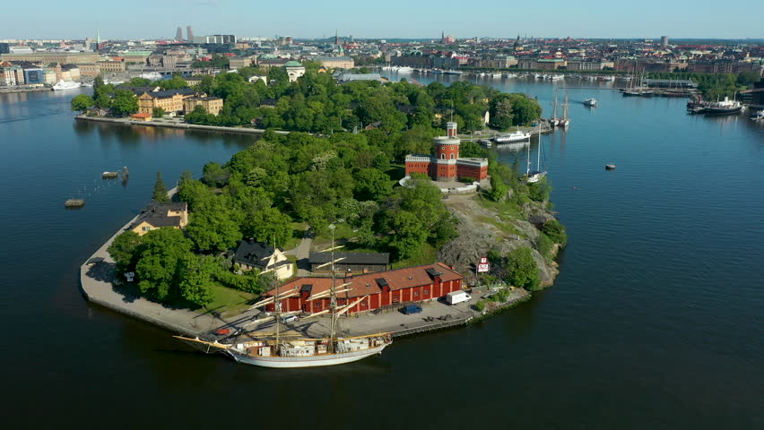 Aerial view of green island with historical building and waterfront
