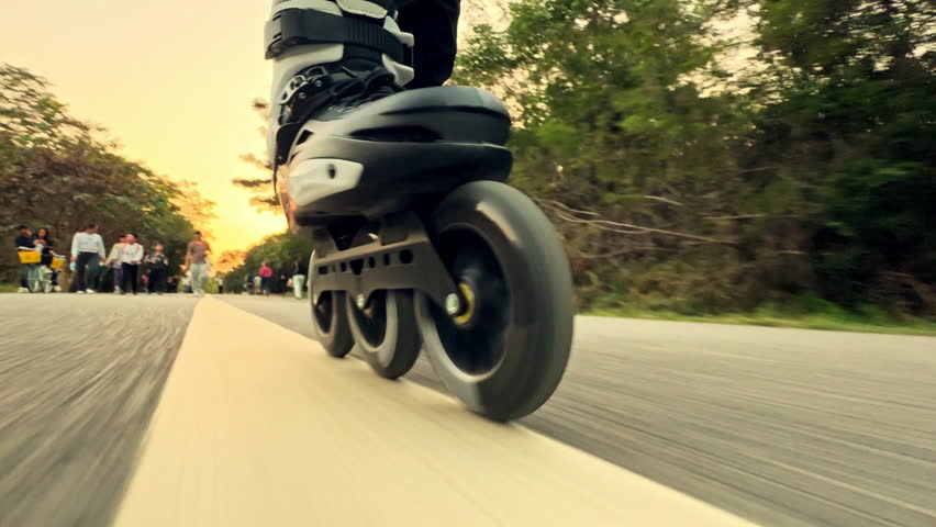 Fast man rollerblading close up park. Sporty teen guy enjoy roller skating. Skater boy rollerskating city street. Blades closeup low angle view. Joyful person ride. Fun active kid wear wheel shoes.