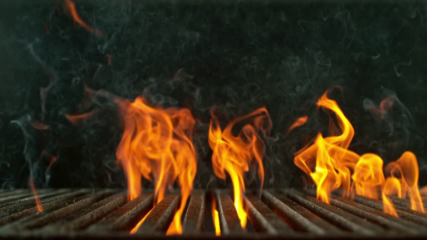 Super Slow Motion of Fire Flames with Cast Iron Grate Isolated on Black Background . Filmed on High Speed Cinema Camera at 1000 fps