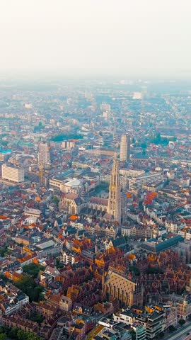 Vertical video. Antwerp, Belgium. Panorama overlooking the Cathedral of Our Lady (Antwerp). Historical center of Antwerp. City is located on the river Scheldt (Escaut). Summer morning, Aerial View. R