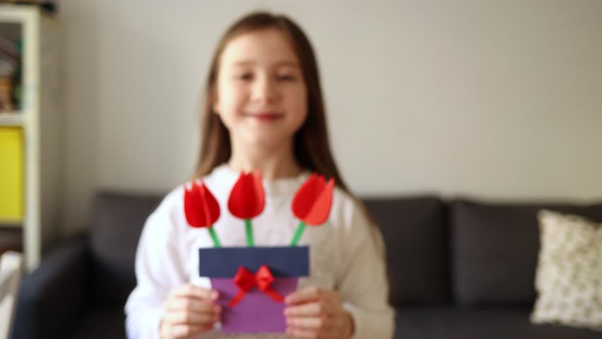 card with bouquet of paper flowers for mother's day, March 8 or birthday. DIY create art for children. craft for kids. girl holds out gift - gives to her mom