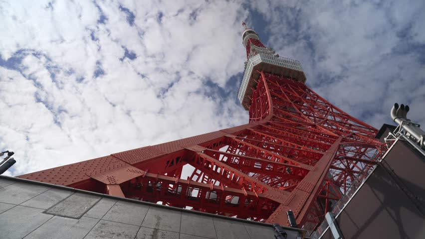 View of Tokyo Tower against blue sky and clouds during daylight, Shiba-koen in Minato City, Tokyo, Honshu, Japan