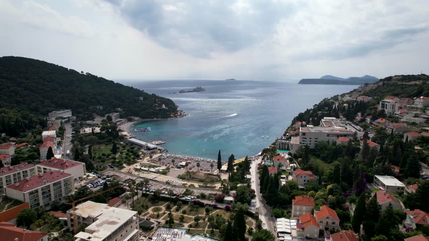 Sunset beach in Lapad Cove promenade, Dubrovnik. Aerial zoom in