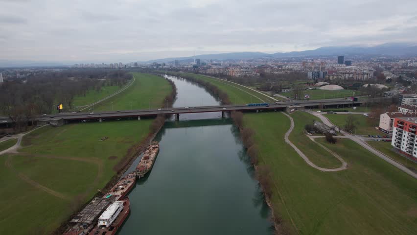 Panorama of the river Sava flowing through Zagreb the capital city of Croatia and a view of the famous Bridge of Youth with the trams and vehicles passing over it