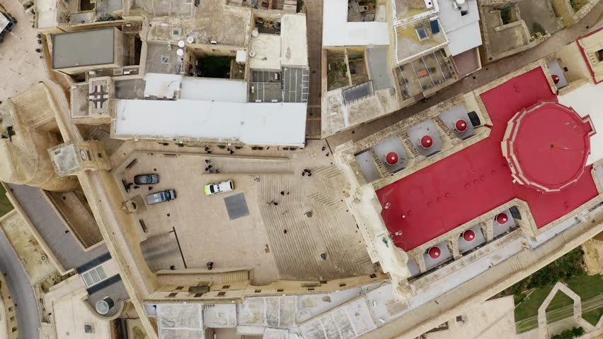 Aerial top down shot of Cittadella Gozo and the cathedral of the assumption in Gozo Island during cloudy day, Malta 4K drone