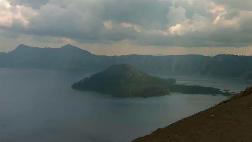 Wizard Island under dramatic skies in Crater Lake National Park, Oregon