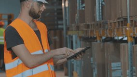 A storekeeper with a tablet in a warehouse checks the goods. Inventory in a large multi-level warehouse. Warehouse workers doing inventory control with a tablet computer. - Powered by Shutterstock - Get 15% off with code: PIKWIZARD15