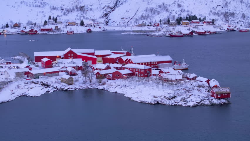 Aerial view of Hamnoy, a picturesque fishing village in the Lofoten Islands, Norway, showcasing red cabin fish factory set against breathtaking winter landscape